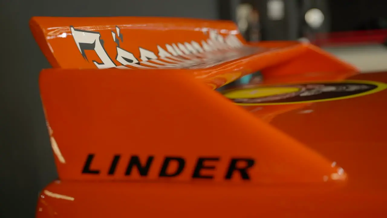 Orange Rear Spoiler of vintage old BMW e30 car during Fan meeting close up