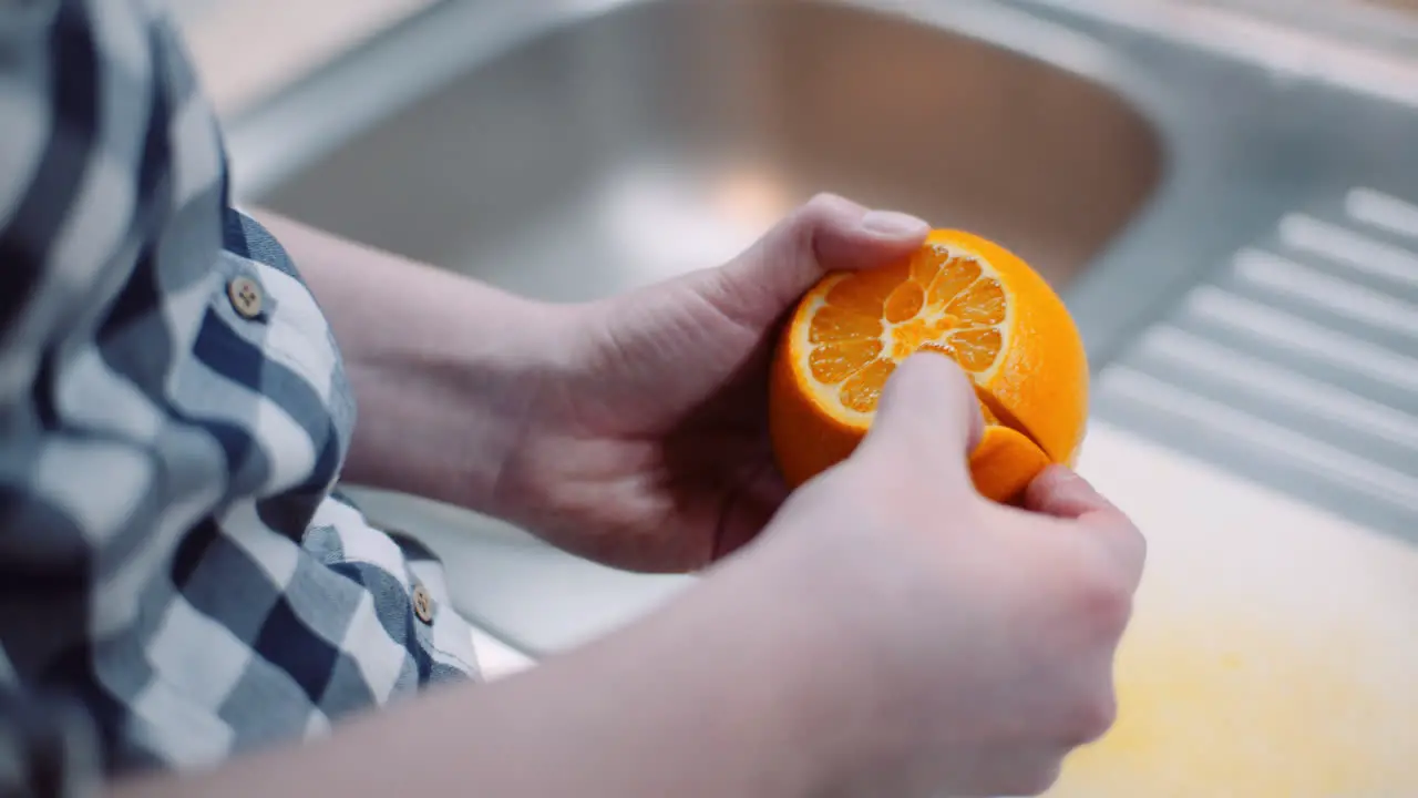 Close Up Of Woman Is Peeling Oranges