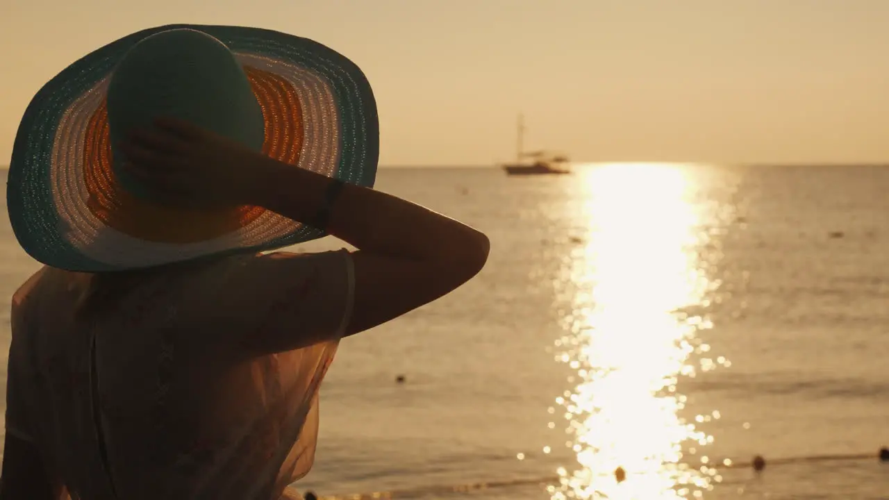 A Young Woman Meets The Sunrise On The Pier He Sits And Looks At The Sun And The Ship In The Sea Dre