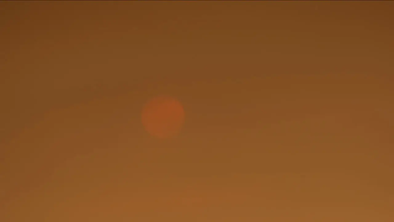 Time lapse of sun setting behind smokey skies