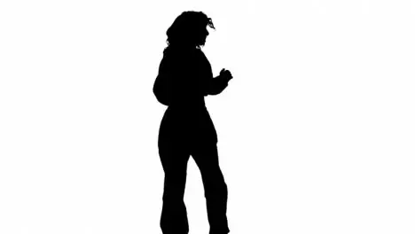 Studio Silhouette Of Woman Dancing Against White Background