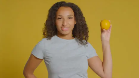 Portrait Shot of Young Adult Woman Holding Orange