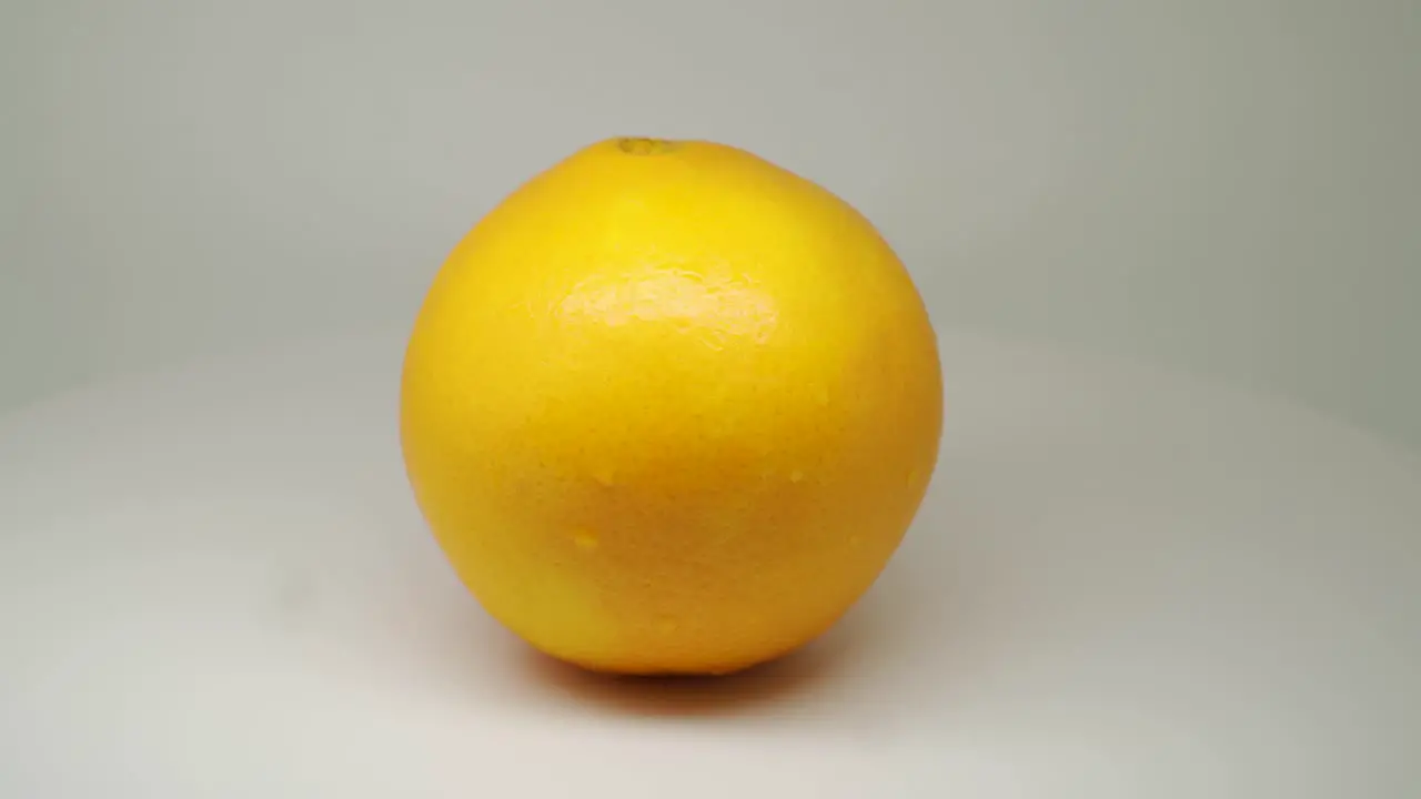 Fresh Orange Fruits Rotating and Spinning in the Turntable With White Background Close Up Shot