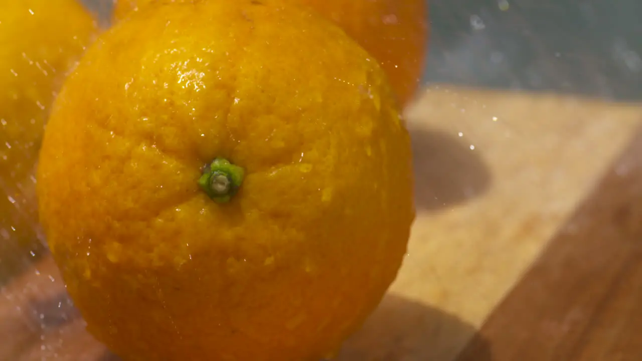 Washing fresh ripe navel oranges in the sunlight