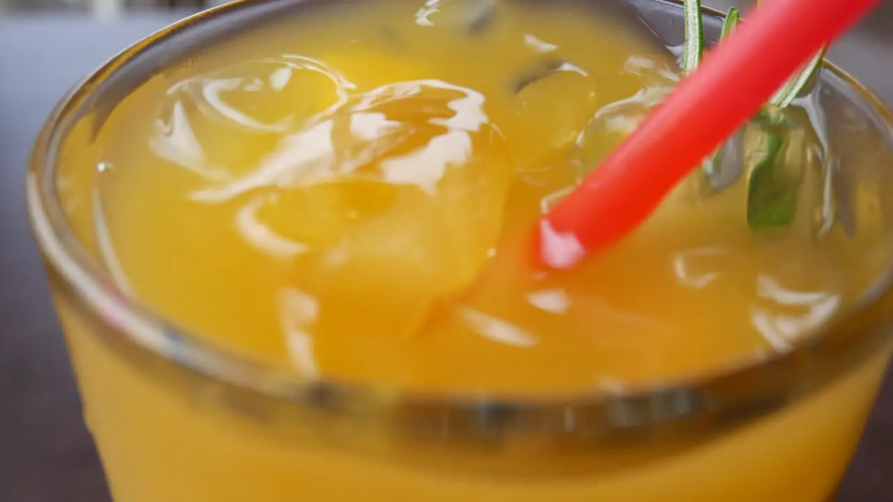 Cold orange drink in a thick glass Close up