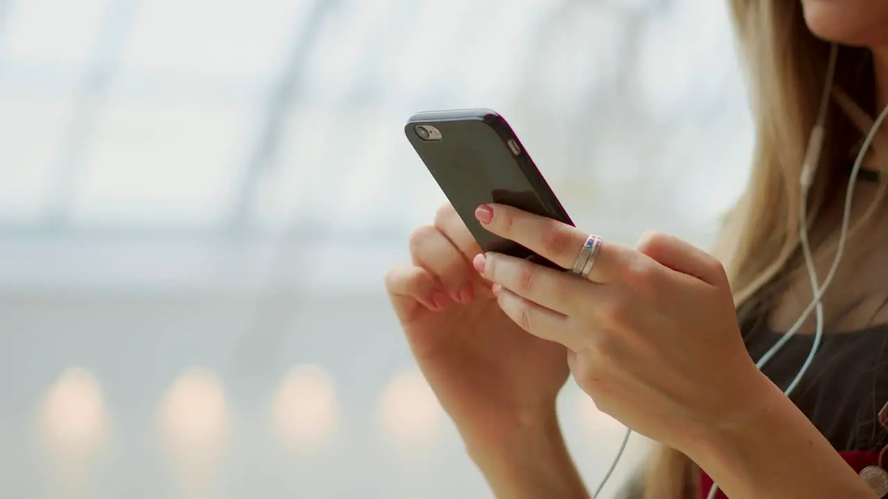 Happy teenage girl holding bags with purchases smiling while looking at phone in shopping center Received good news reading message texting Horizontal photo banner for website header design