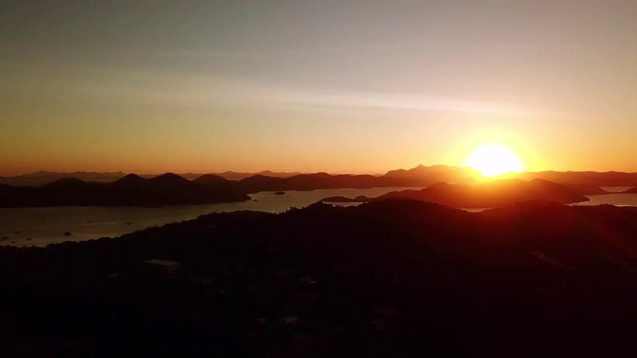 Aerial drone shot of beautiful sunset with vista of ocean islands and mountains in Palawan Philippines