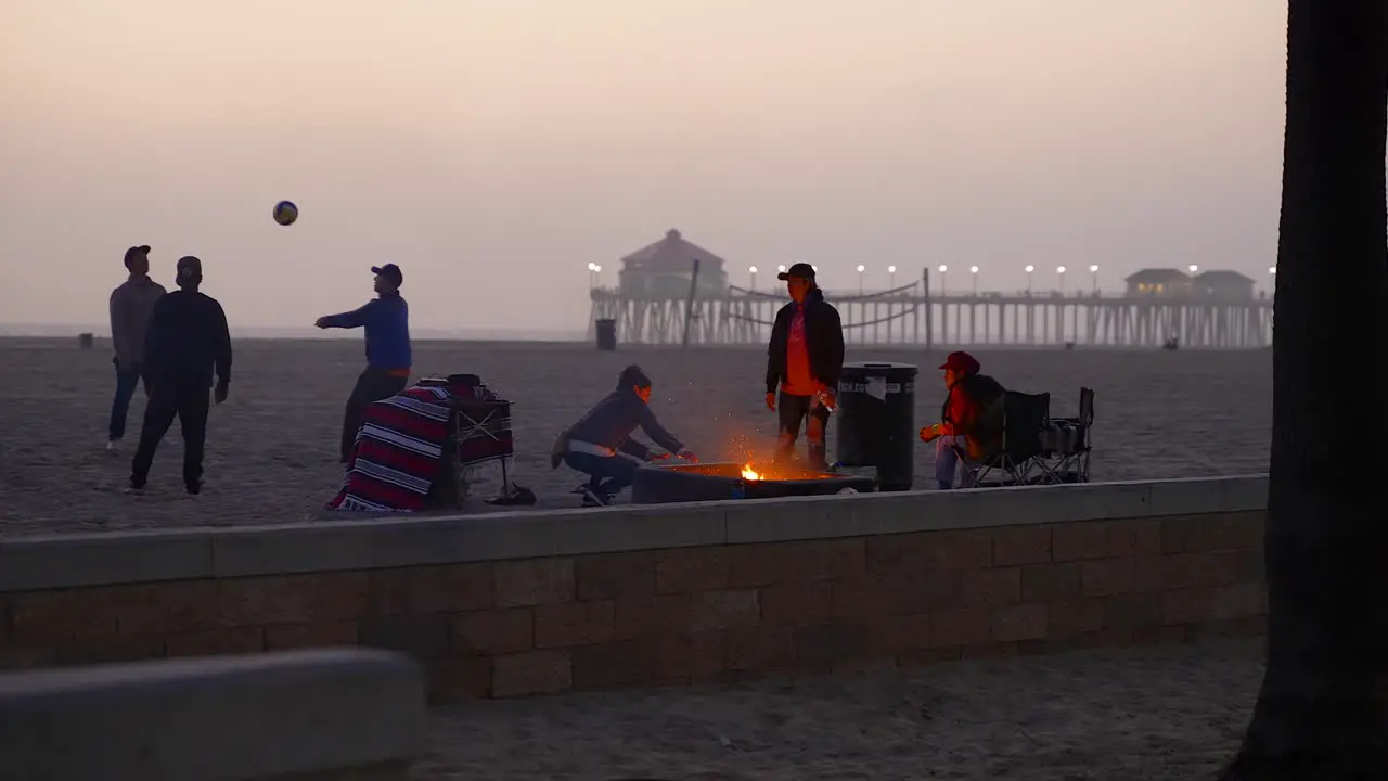 Friends enjoying the evening around a fire pit in Huntington Beach California