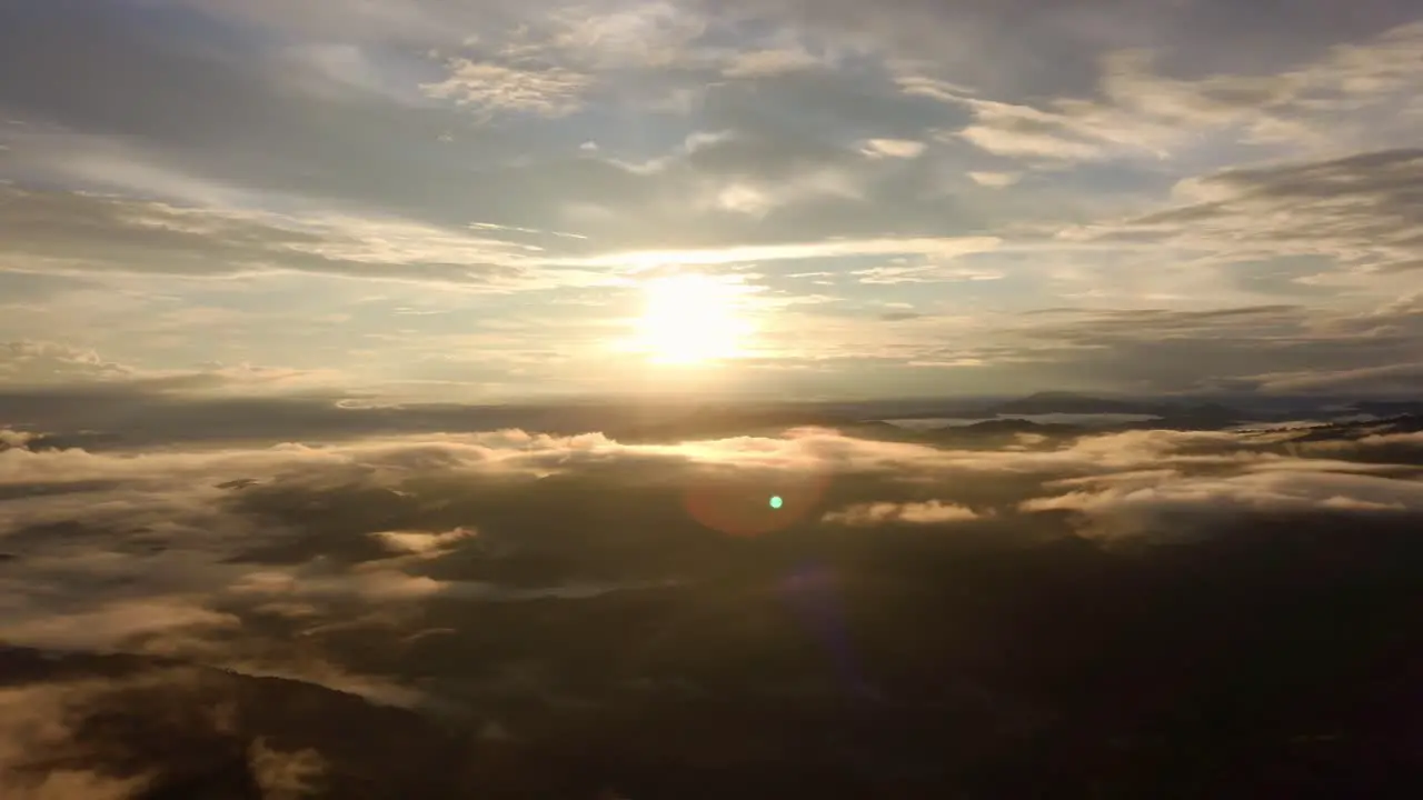 Bright Orange Large Sun In Cloud Sky With Lens Flare And Shadows 4K Costa Rica Drone