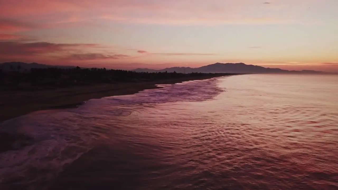 Aerial low angle dolly in near romantic beach in Mexico in the evening