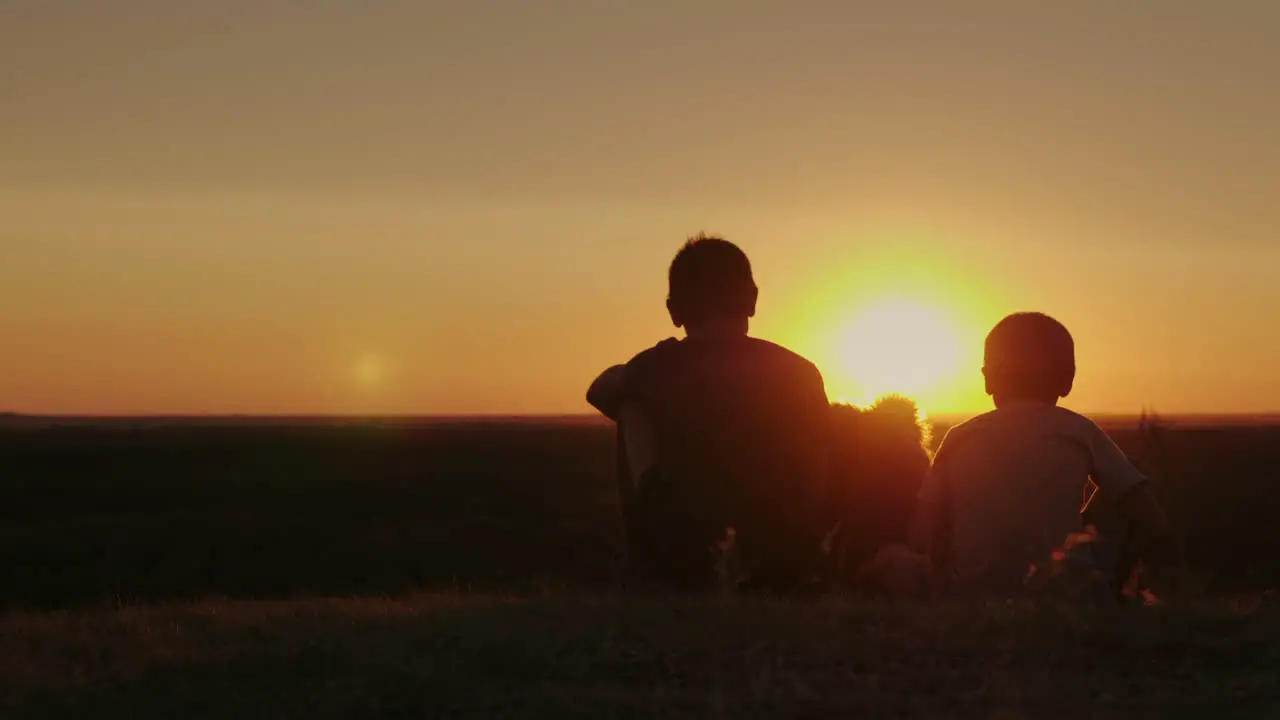 Two Rural Boys Play With Their Favorite Dog At Sunset 1