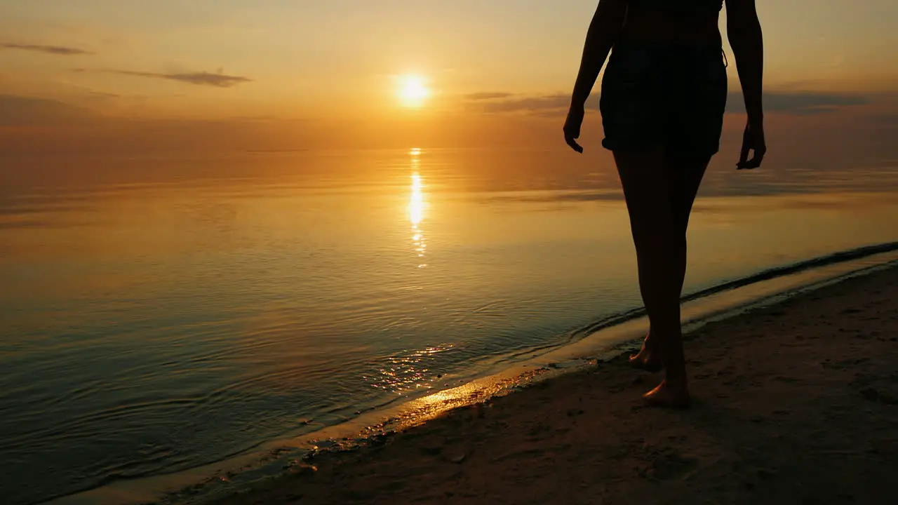 Mother With Two Children Go Swimming In The Sea At Sunset Laughing