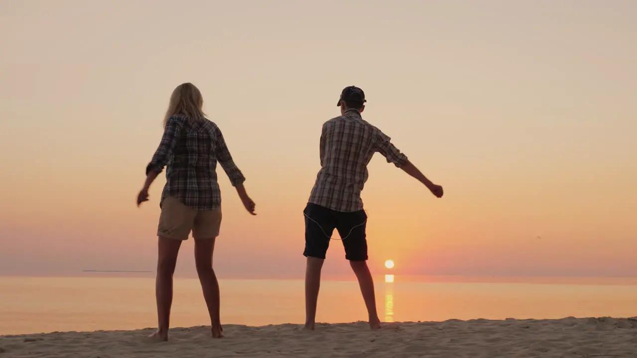 A Woman And Her Teenage Son Dance Together A Funny Dance On The Beach Learn Fashionable Dance Moveme