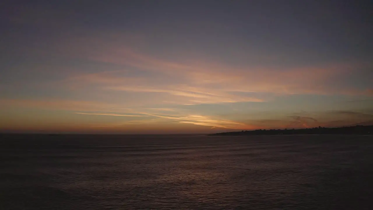 Drone Flight at sunrise over the ocean in the sky with clouds in early spring