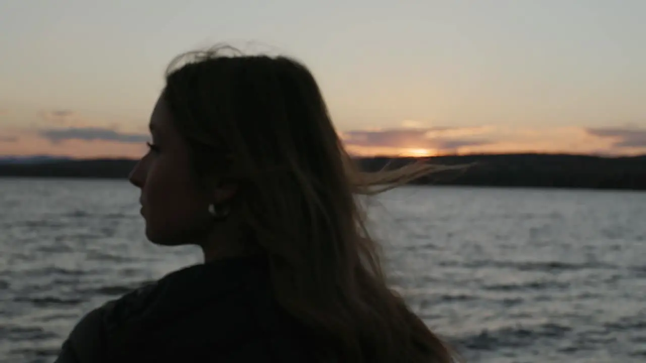 Woman On Vacation Enjoying The View Of A Sunset Beach