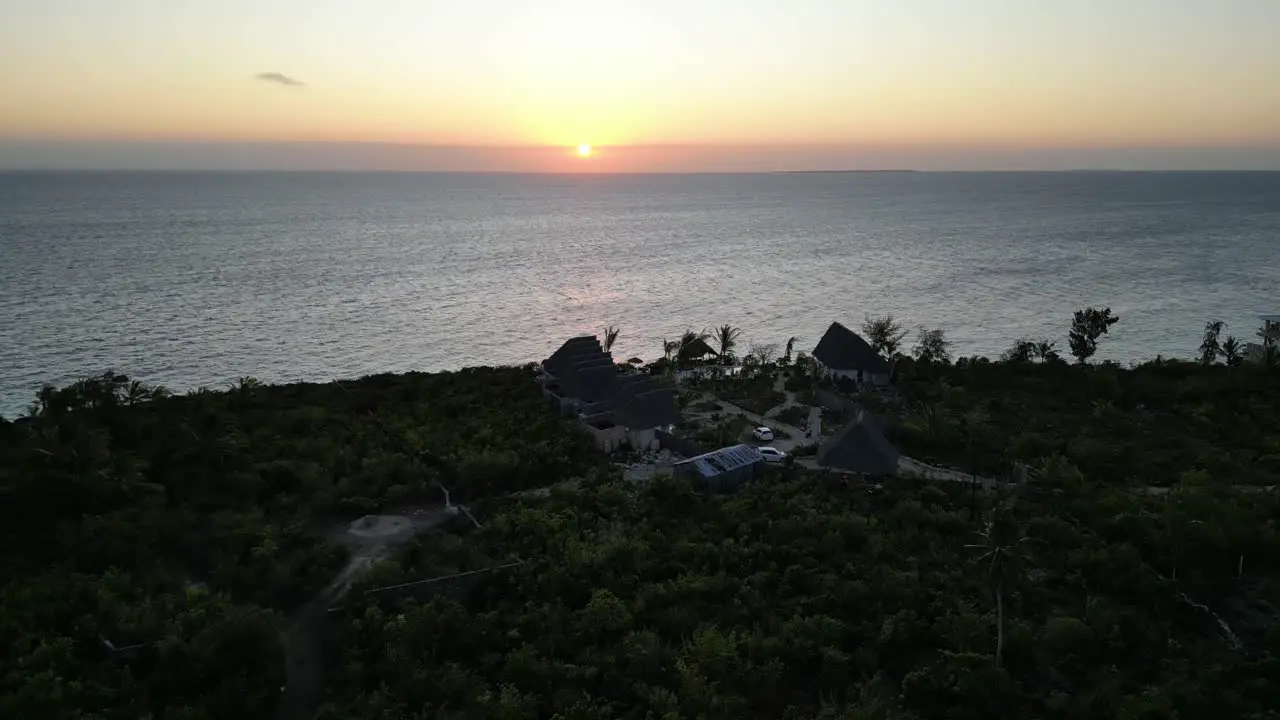 Kisini Beach bungalow resort with ocean sunset in East Zanzibar Island Tanzania Africa Aerial approach shot