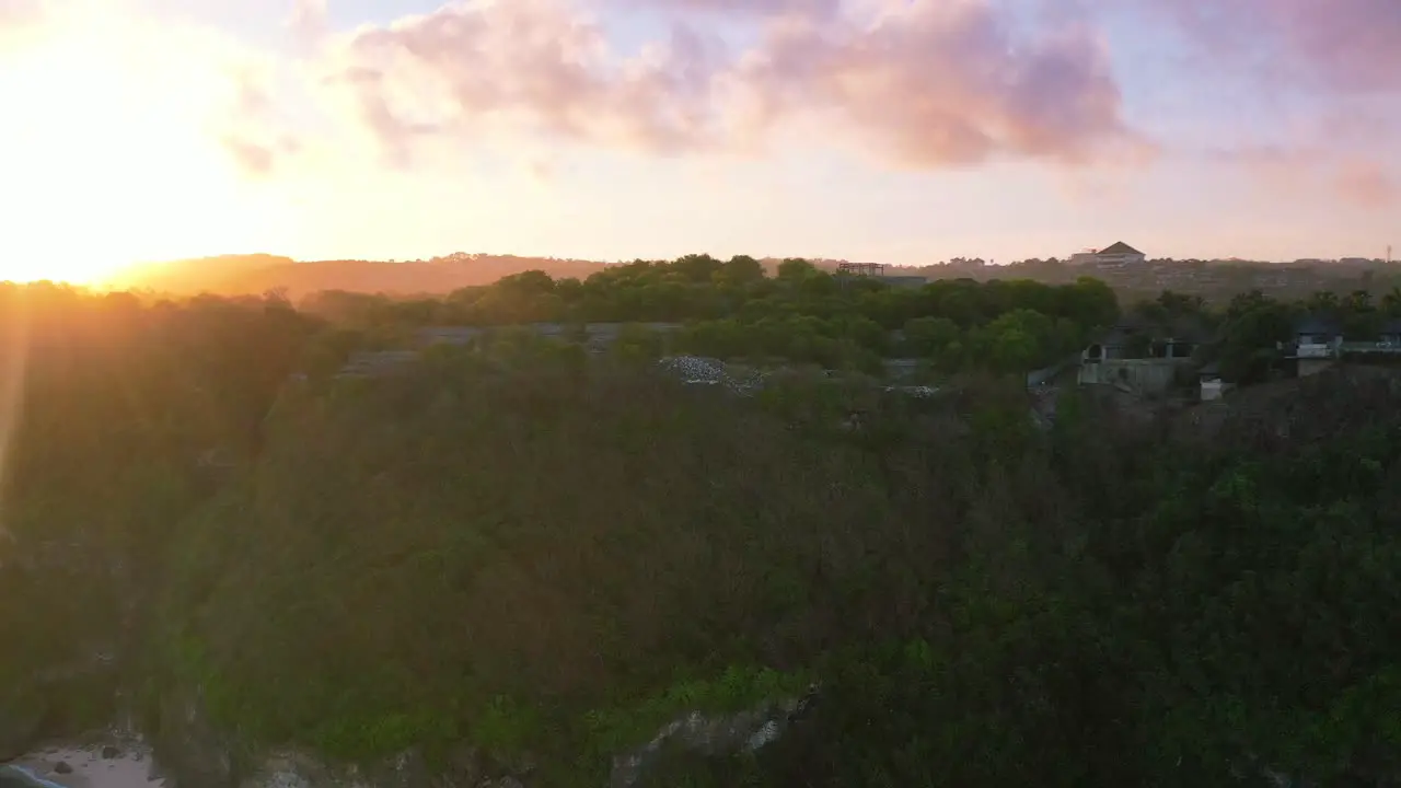 aerial coastline of mountain cliffs in uluwatu bali indonesia at sunset