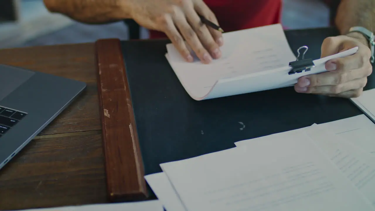 Male hands working with business papers Close up of male hand sign document