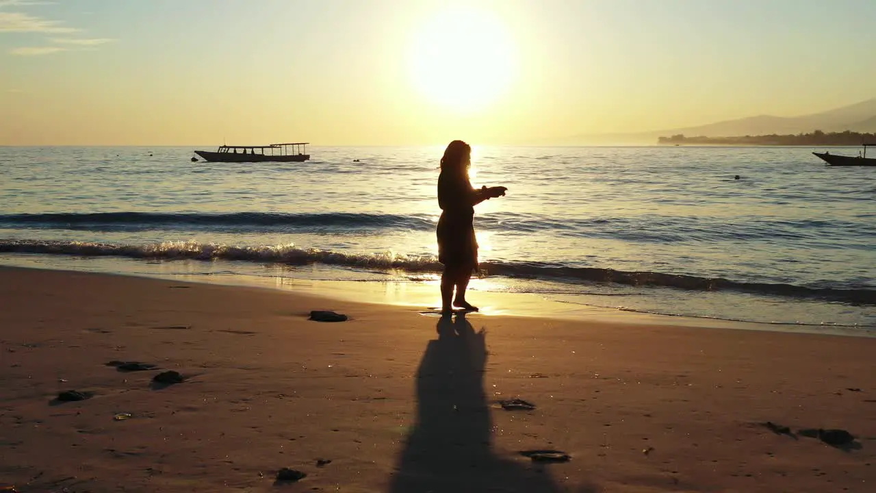 A Woman Taking Photo At The Shore Under The Shadow Of A Glowing Sunset In Krabi beach Wide Shot