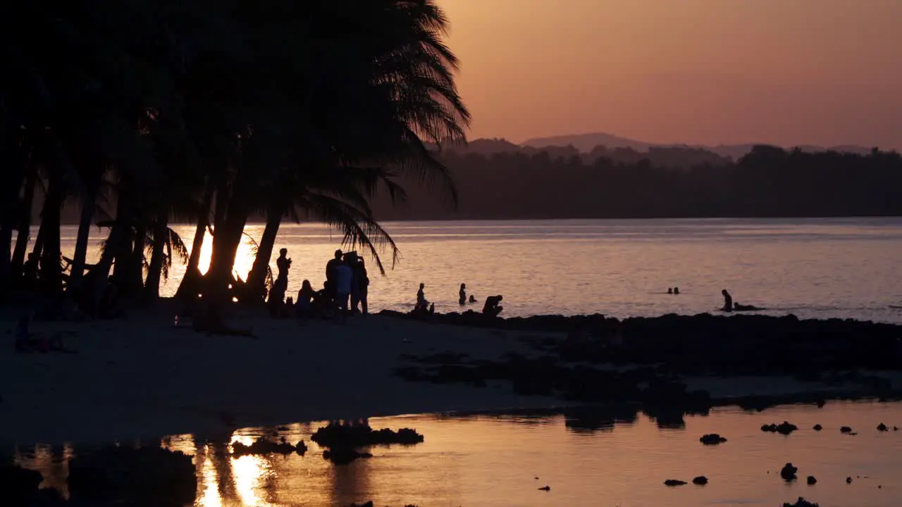 People enjoying the water in the background at sunset