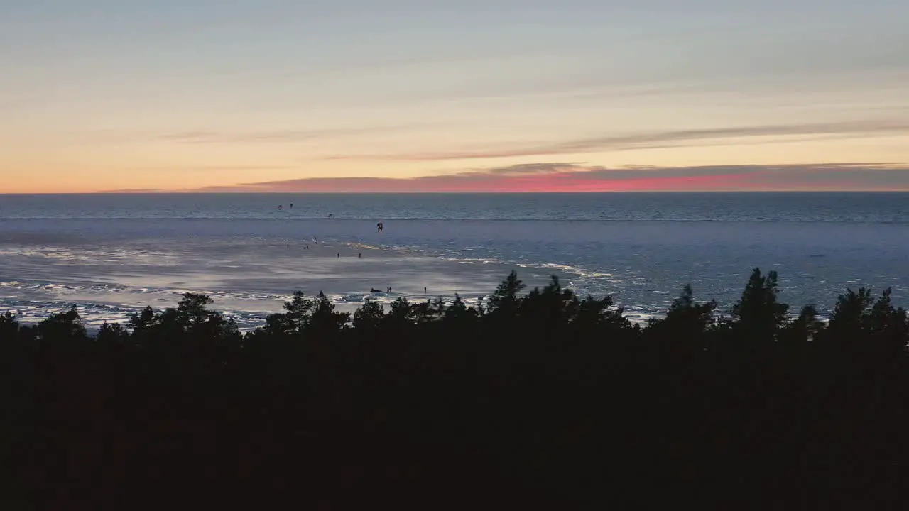 kitesurfers enjoying the frozen bit of the Baltic sea during the cold winter