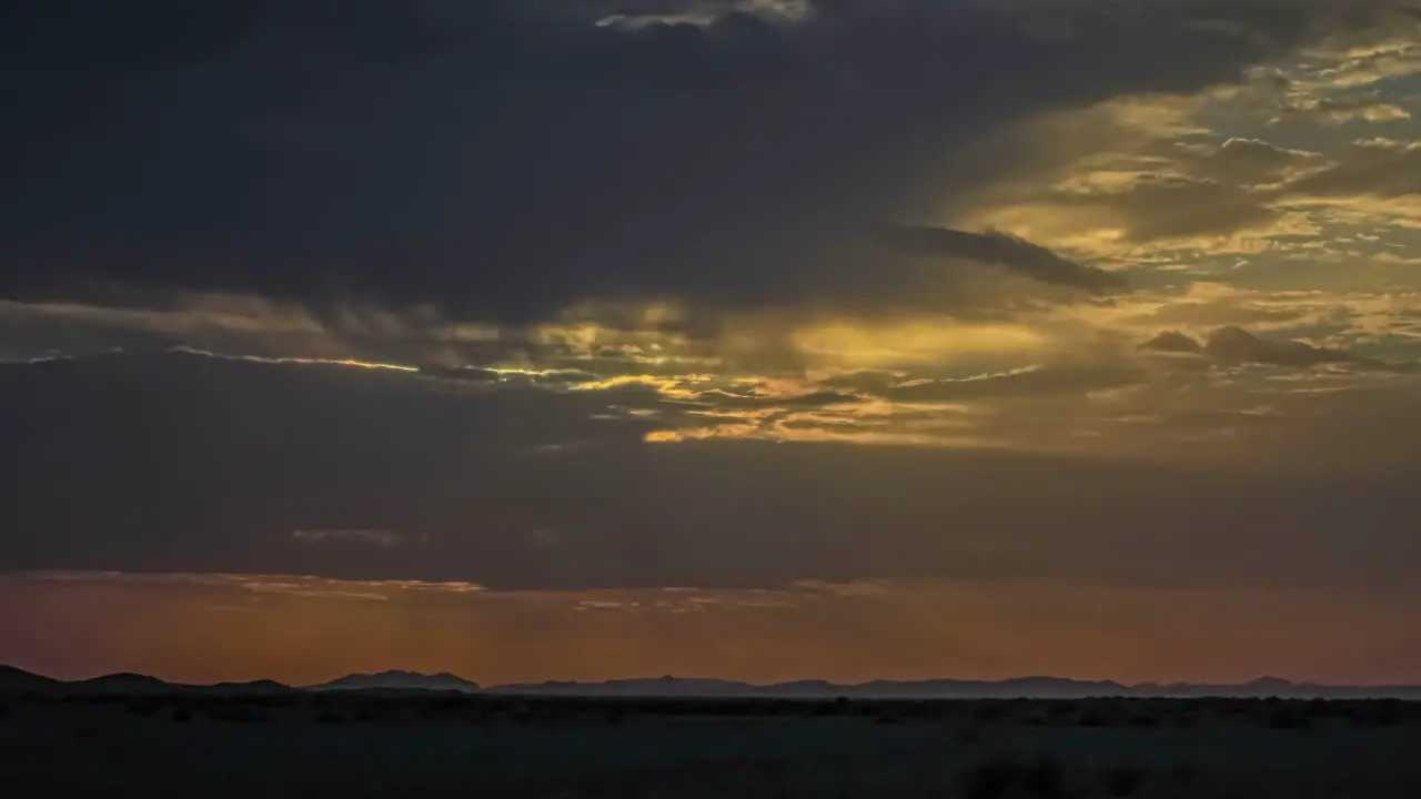 Incredible timelapse shot of sunset through the clouds over Majestic sahara desert during evening time