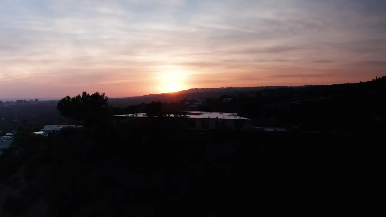 Rising aerial shot of Beverly Hills hillside during sunset