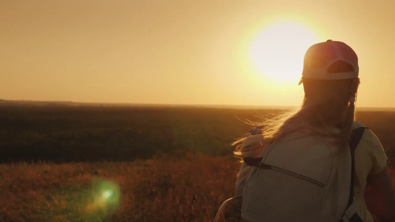 A Carefree Child With A Knapsack Behind Him Runs Towards The Sun Summer Holidays And Freedom Concept