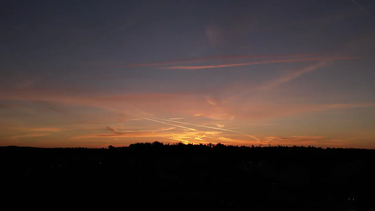 Sunset over a small village in Germany Saxony wind turbines in background