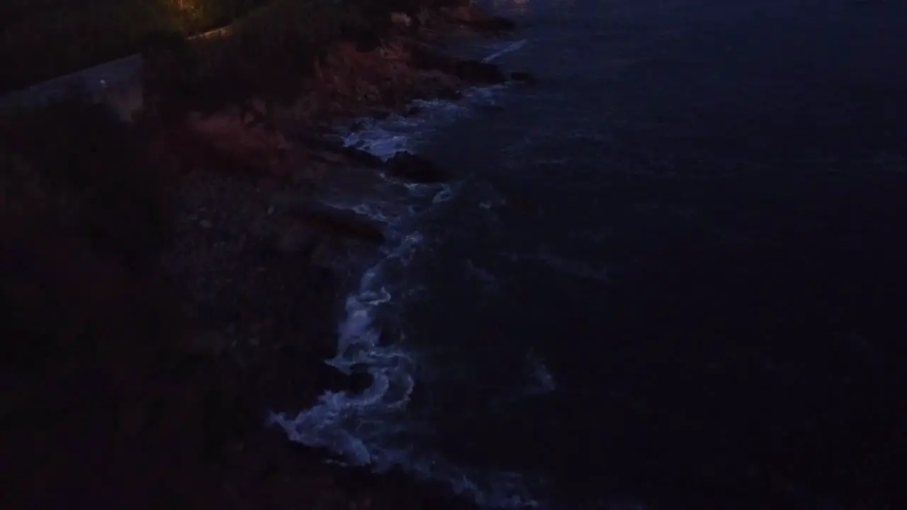 Drone flying over beach at sunset