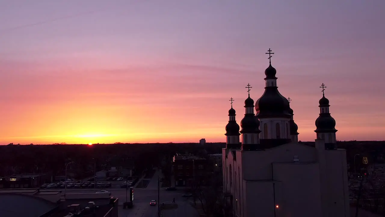 Slow Orbit Church Aerial City Street Traffic Sunset