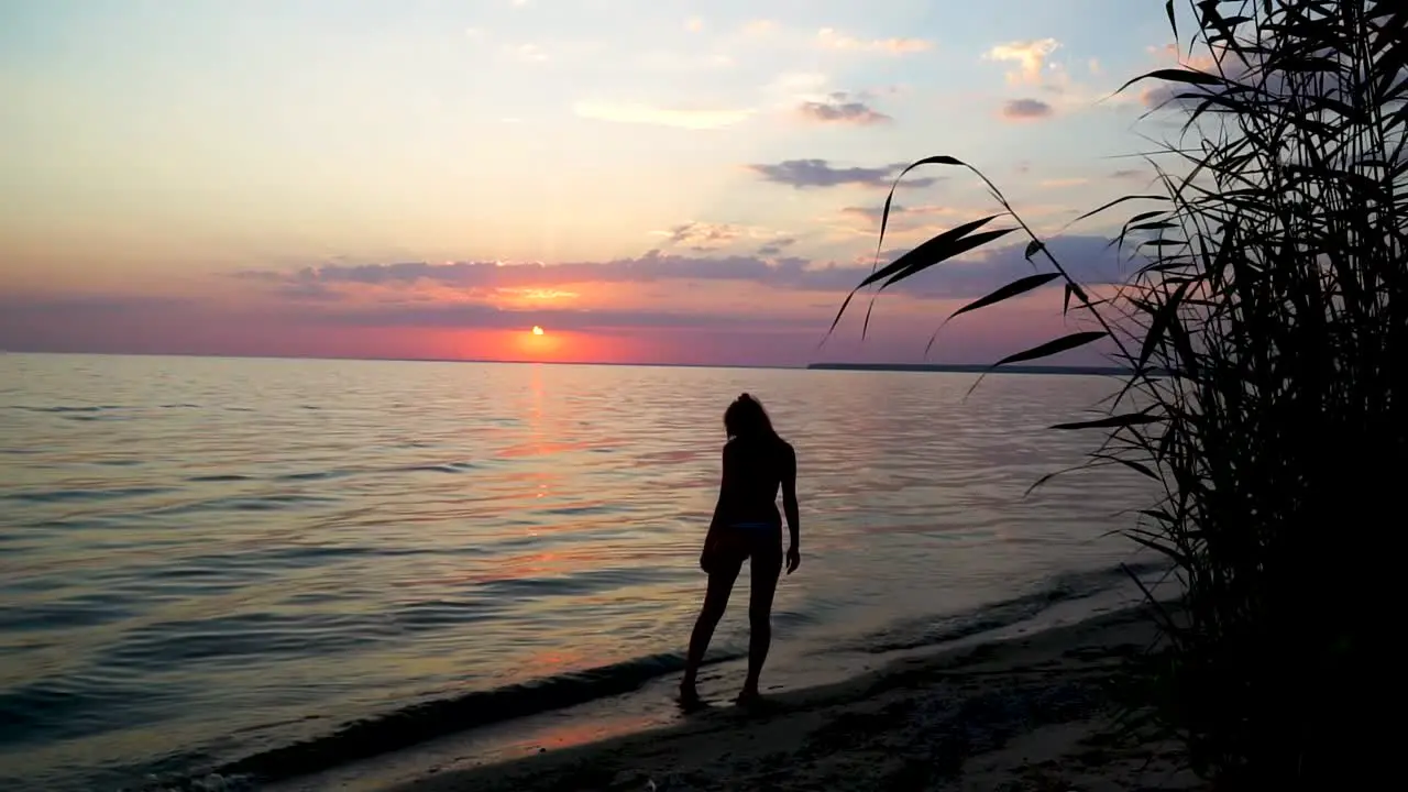 Girl relaxing at the sunset beach