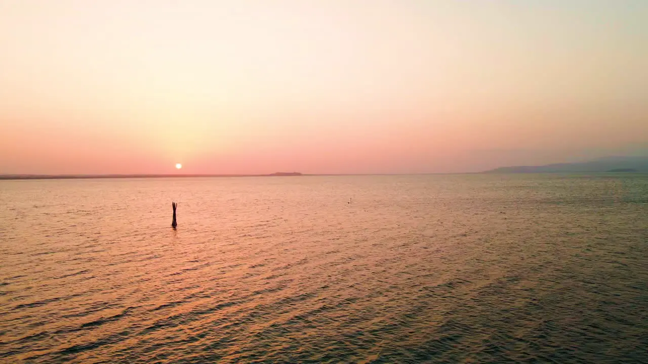 Beautiful cinematic view of the sunset hue over the Trasimeno Lake in Italy -Aerial