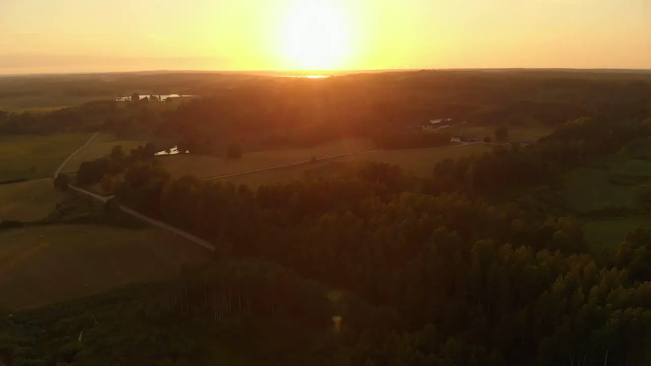 Golden sunset over landscape of agriculture and forest aerial view