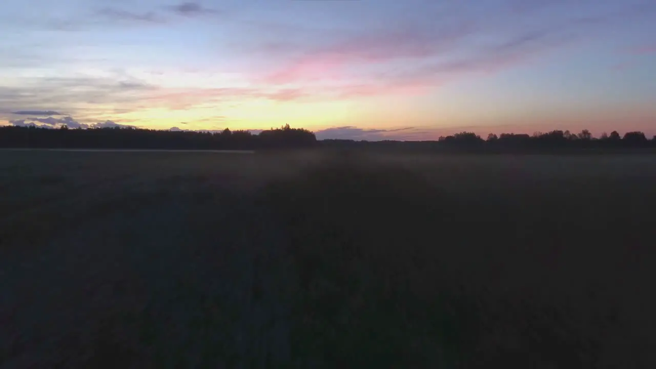 Aerial Low Drone Flight Backwards Through Fog Over Meadow-1