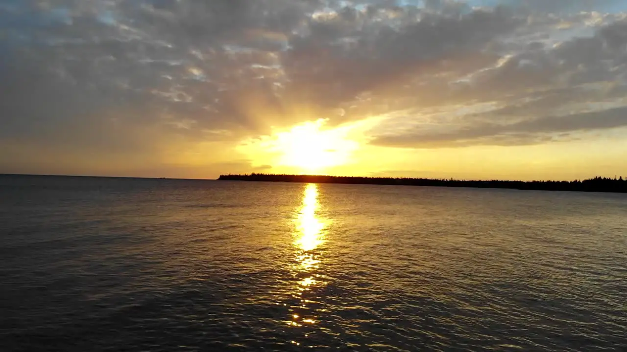 Sunset bursting through the clouds over the ocean and islands