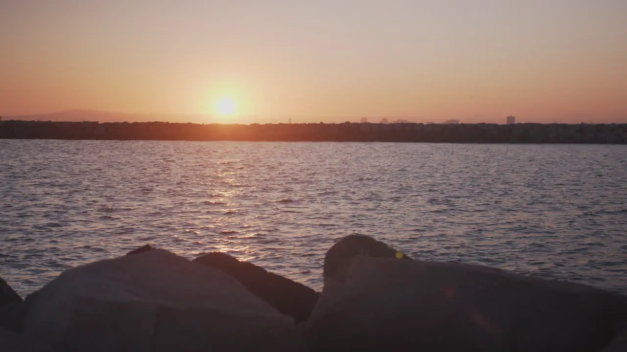 The sun sets over a Long Beach canal