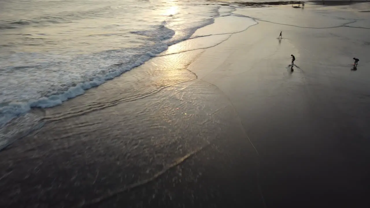 AERIAL Drone shot of people skim boarding