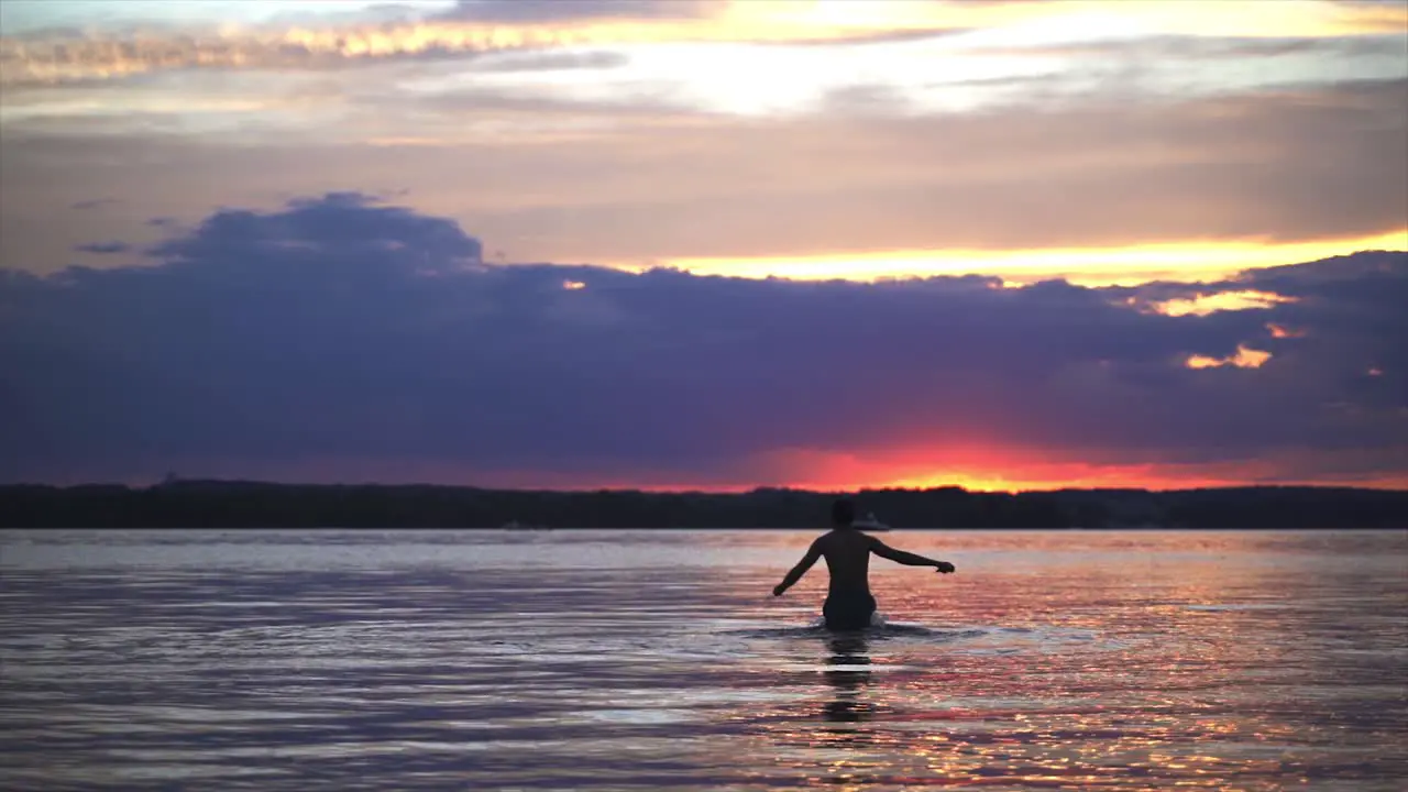 Person Running In The Water During Sunset