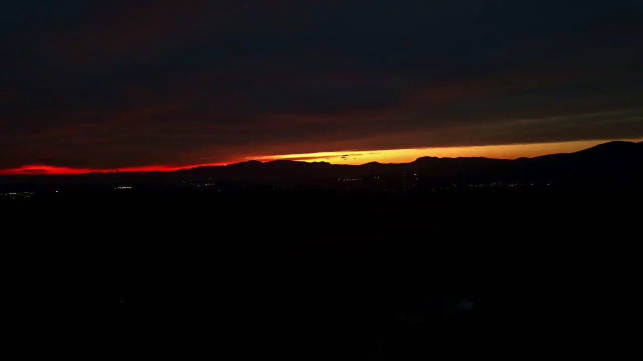 This is a footage of a stunning red and yellow sunset at night the natural colors of the sunset add a magical touch to the scene making the mountains look like they are on fire