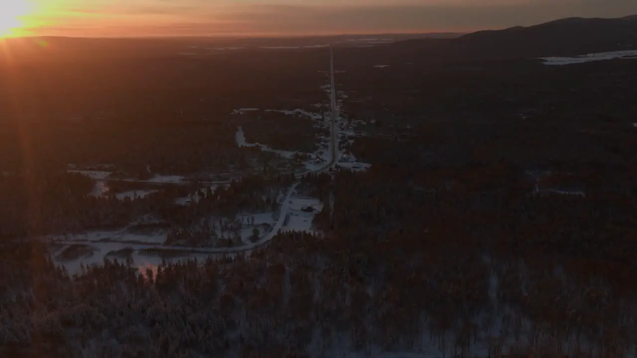 Sunset on Snow covered Road And Forest in Southern Quebec Canada aerial drone shot