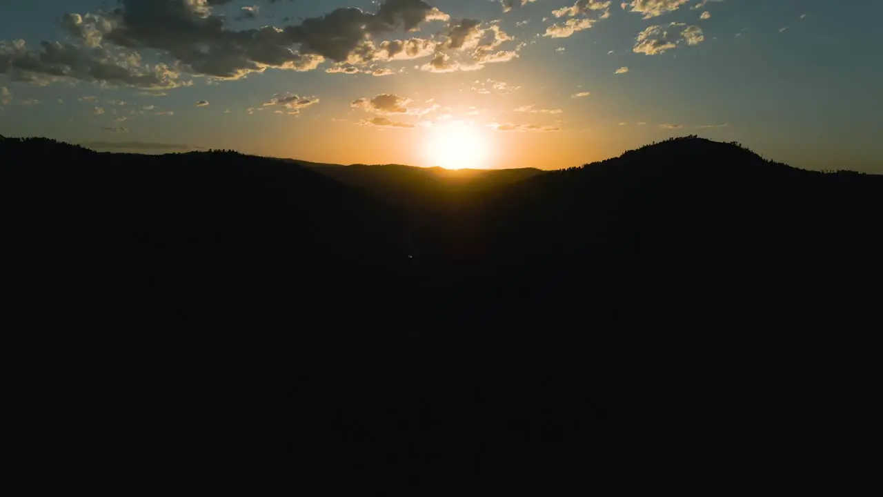 Aerial panning right shot of a sunset in the Black Hills