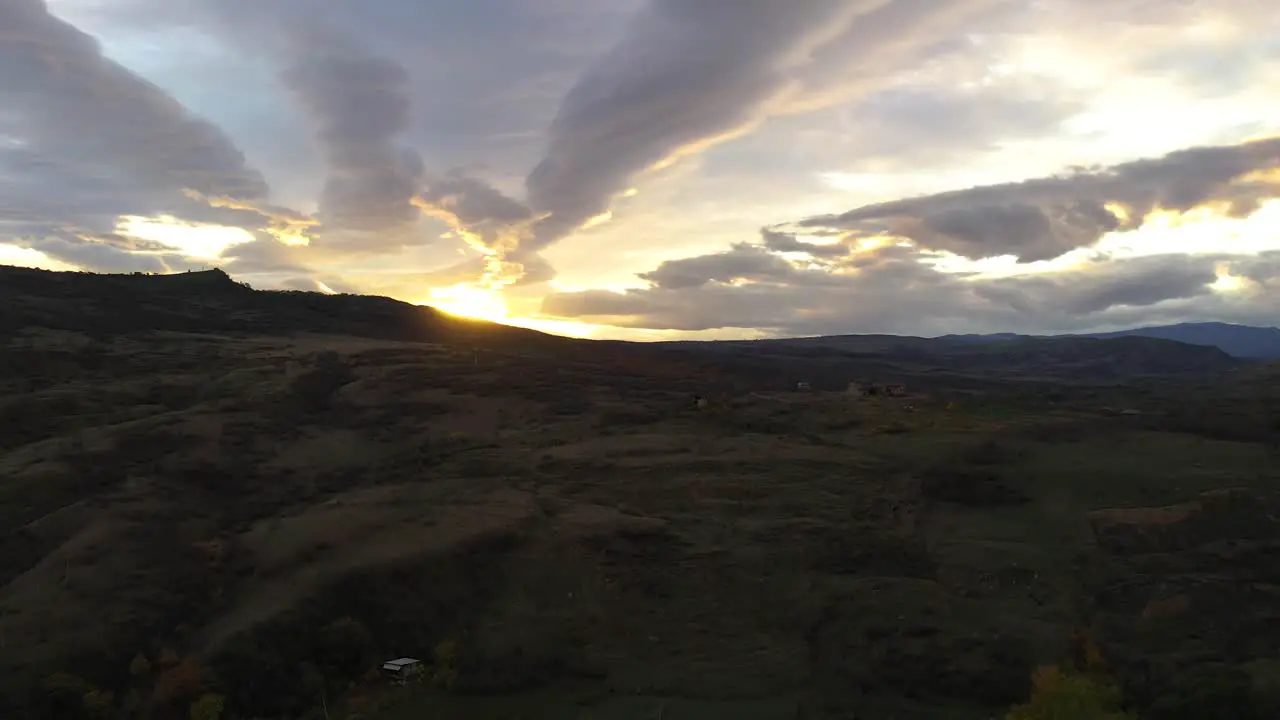 Magnificent Sunset On A Cloudy Sky By The Mountain ascending crane shot