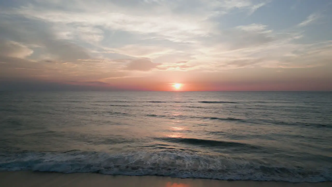 Drone shot over the ocean of the sunset during golden hour