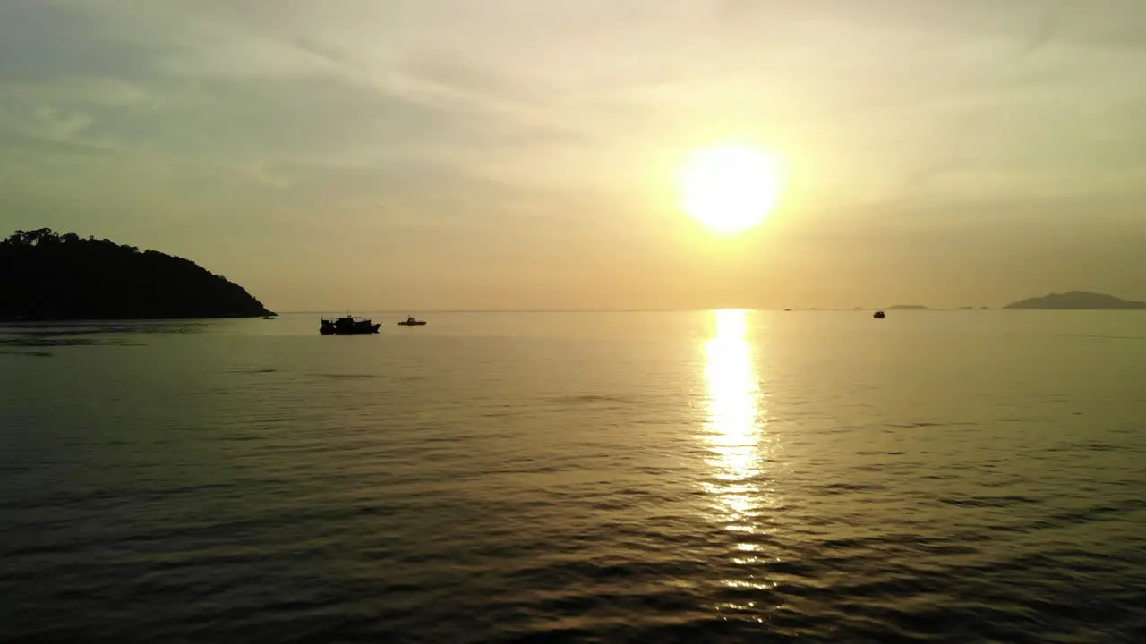 Thai tale boat with golden sunset on the background