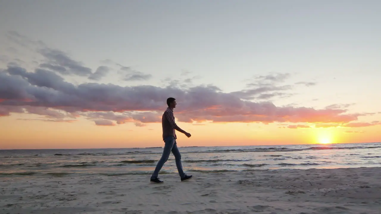 A Man And A Woman Pass Each Other On The Beach At Sunset Random Encounters And Partings