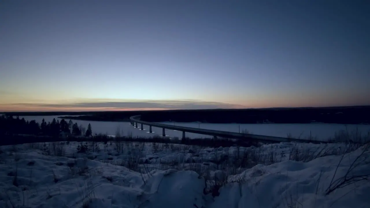 Snowy car bridge during sunset