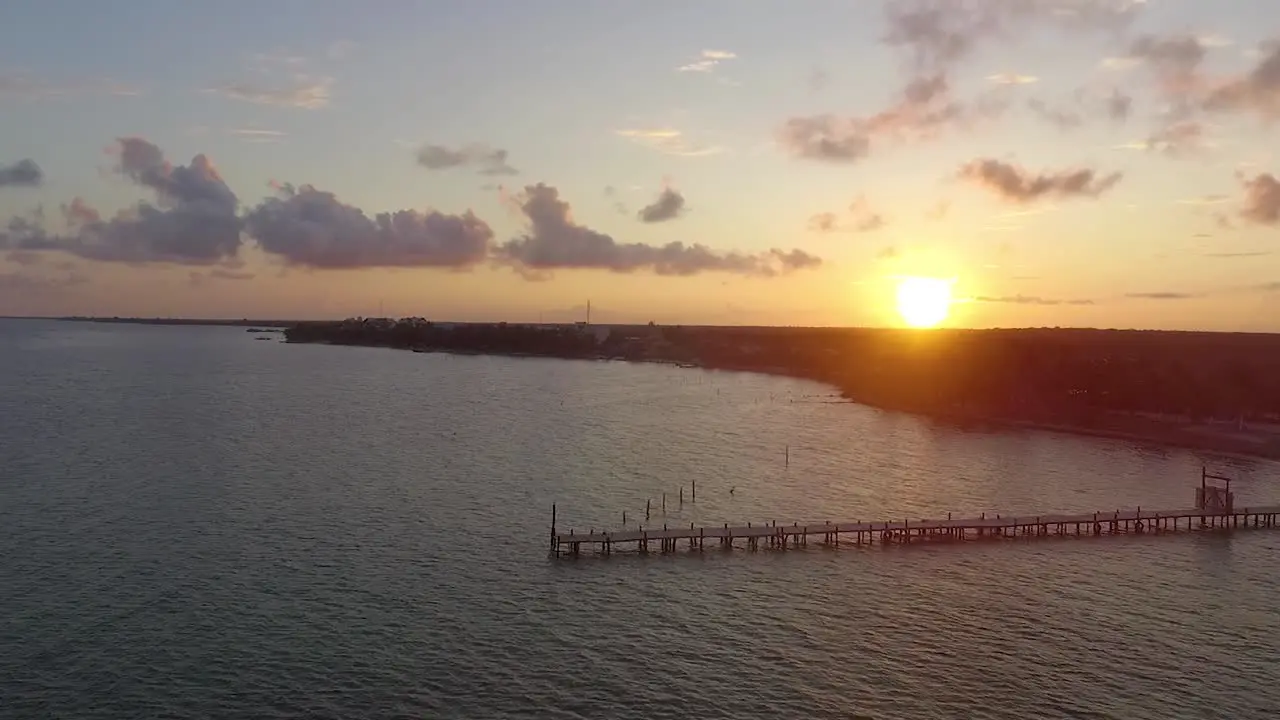 Slow sunset flight towards a Caribbean fishing village