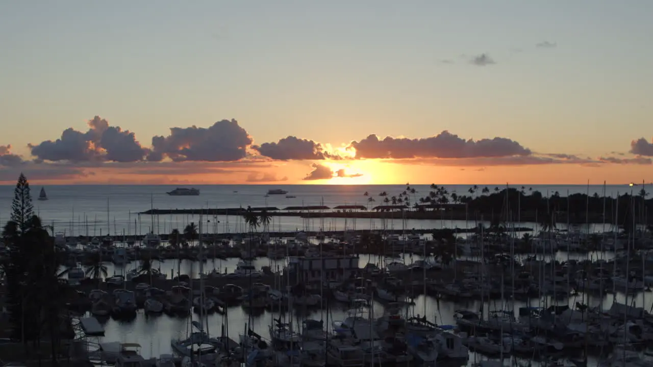 Sunset over boats in Ala Wai Boat Harbor in Honolulu Hawaii on Oahu island