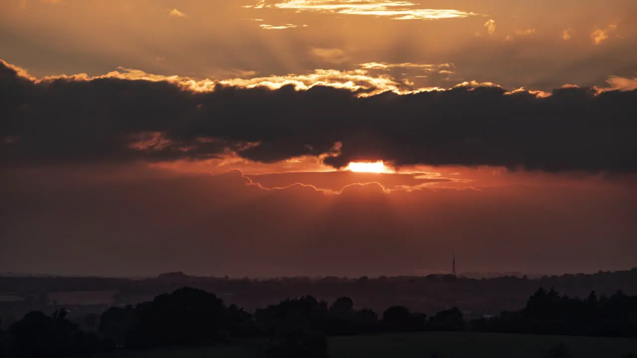 Clouds pass by in a time lapse of a glorious Sunset on a June evening over Worcestershire England UK